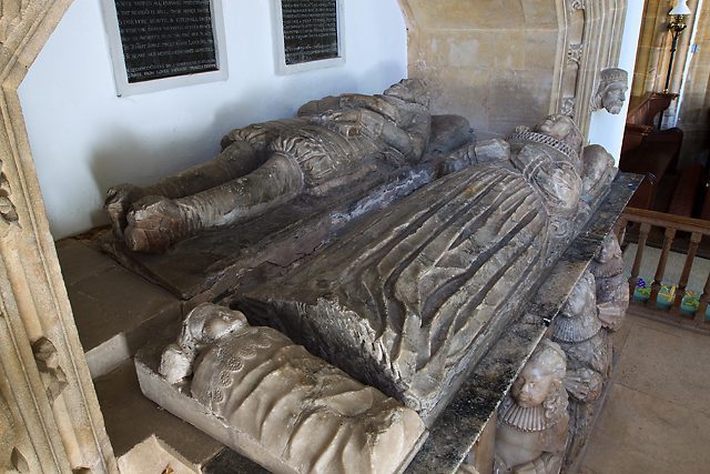 Alabaster effigies of John Coles and his wife lying on a tomb chest in the chancel, with a small effigy of an infant at her feet